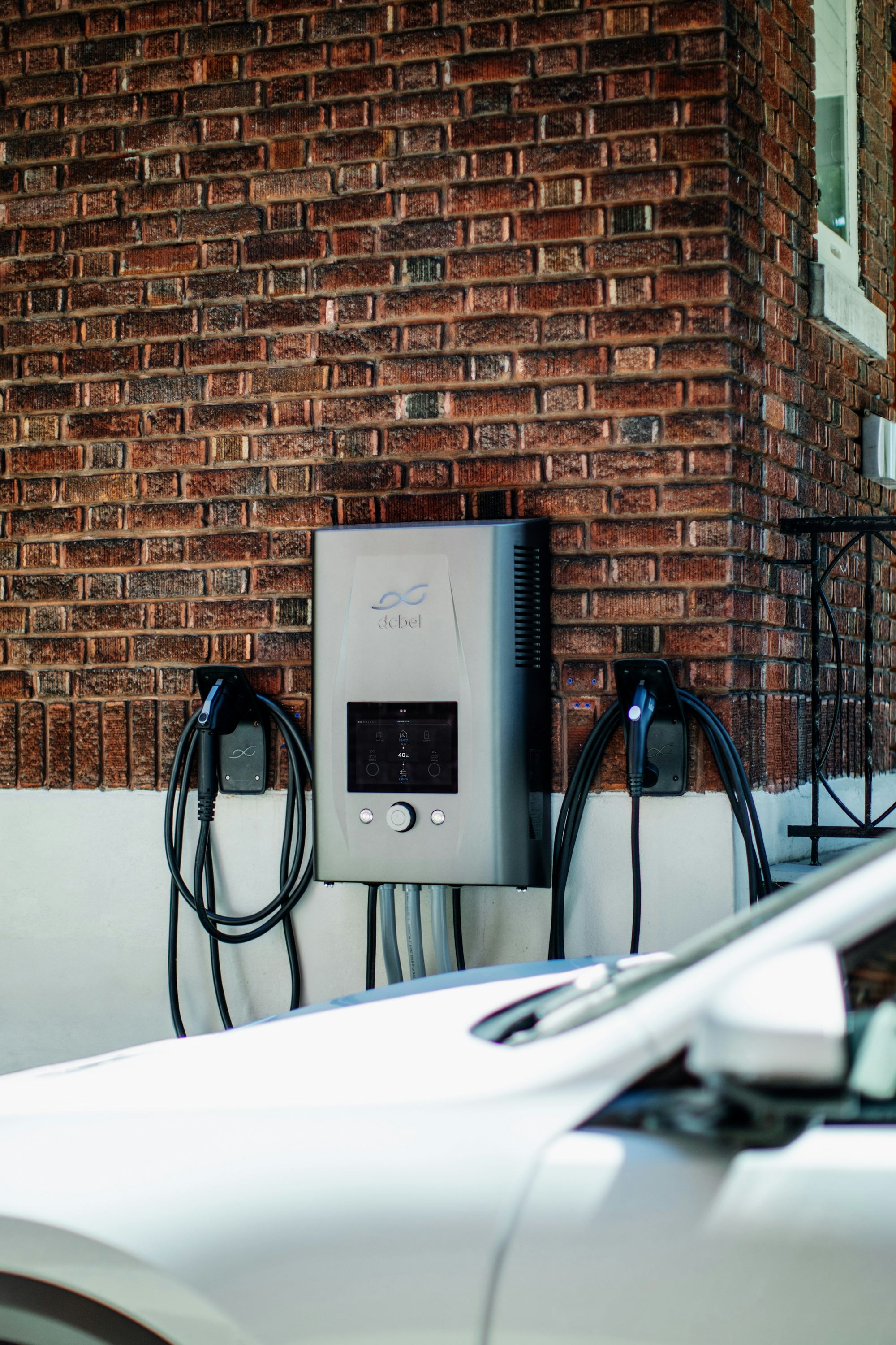 EV charging station mounted on a brick wall