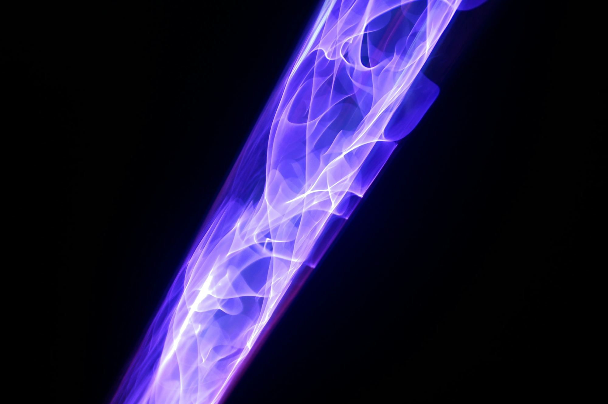 Violet plasma discharge glowing inside a high-voltage column